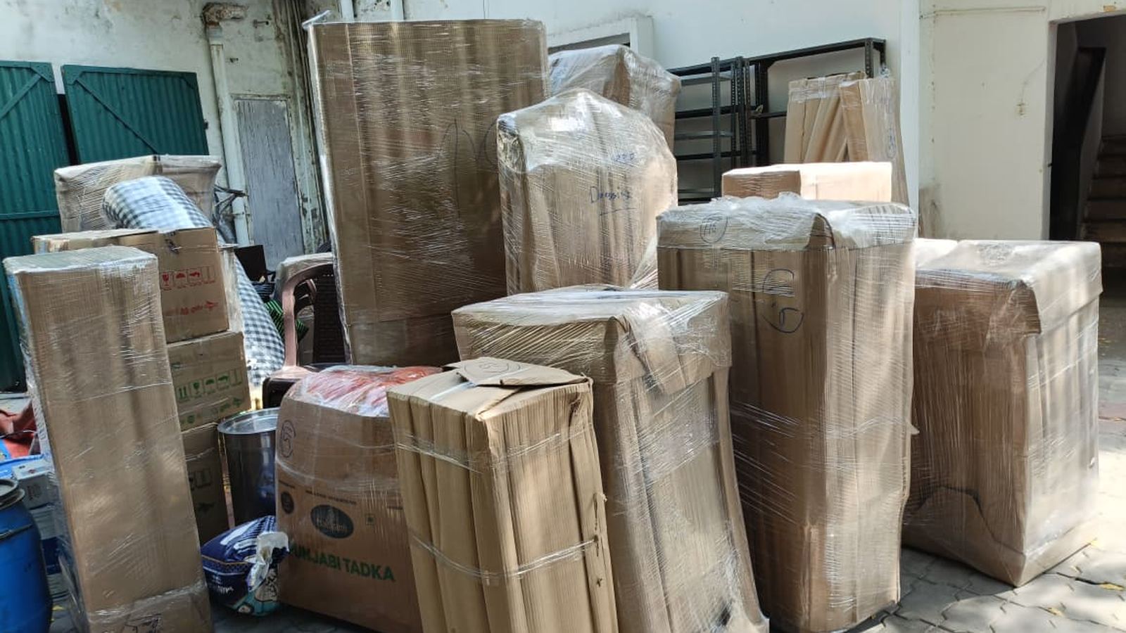 Wrapped furniture and cartons ready for loading at a Lucknow apartment