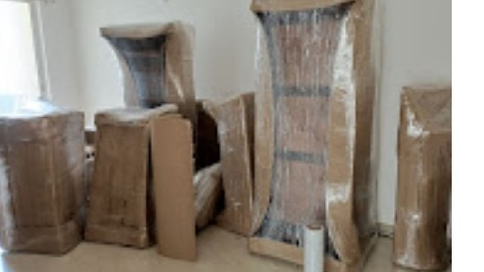 Wardrobe and cartons packed with stretch film before a house move